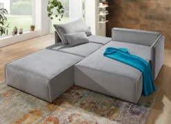 Polsterecke mit Bettfunktion und Hocker